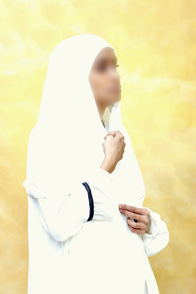Person wearing a white outfit with a yellow gradient background